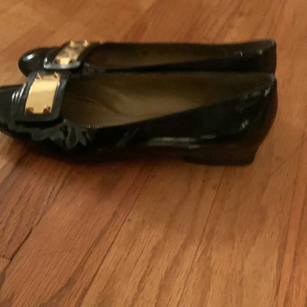 Stuart Weitzman black patent leather loafers with gold plaques and low heel 6